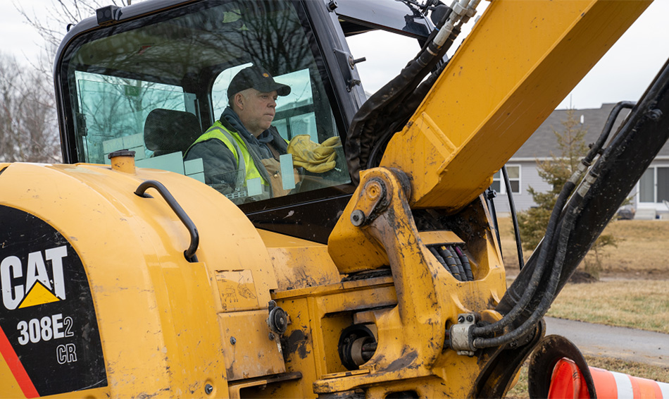 Man driving ditch digger