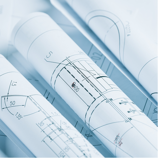 Close-up of several rolled architectural blueprints with technical drawings, measurements, and diagrams visible on white paper, suggesting planning or design work.