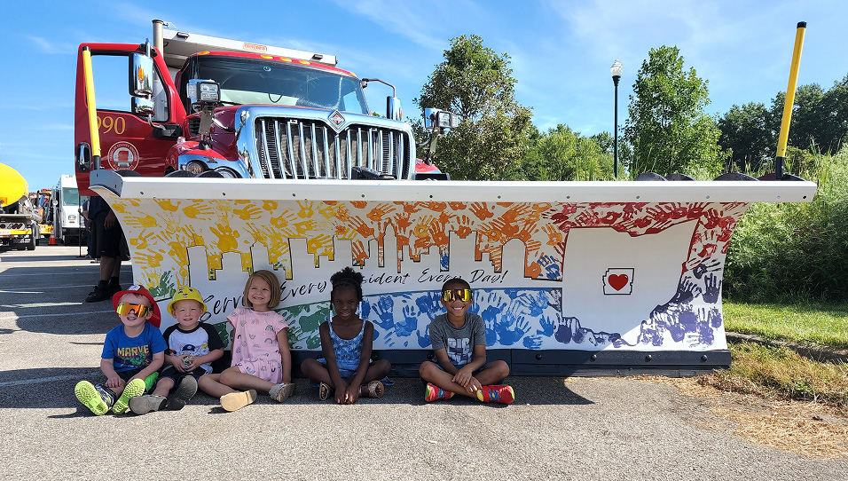 kids sitting in front of plow
