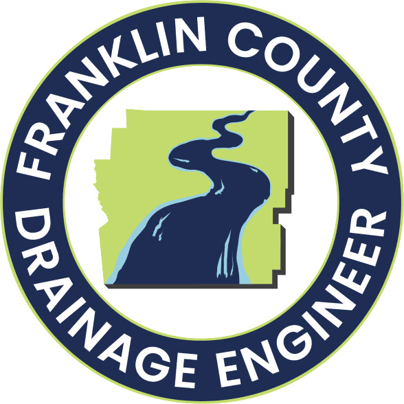 Logo for Franklin County Drainage Engineer, featuring a map outline with a stylized river inside a circular border containing the text “FRANKLIN COUNTY DRAINAGE ENGINEER.”.